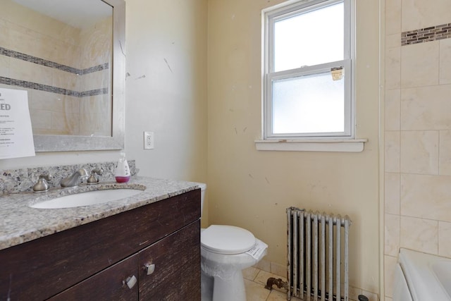 bathroom with toilet, a tub to relax in, vanity, radiator heating unit, and tile patterned flooring