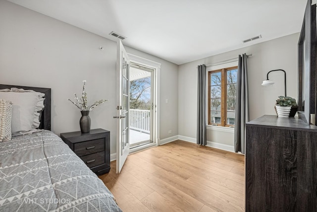 bedroom featuring baseboards, visible vents, access to exterior, and light wood-type flooring