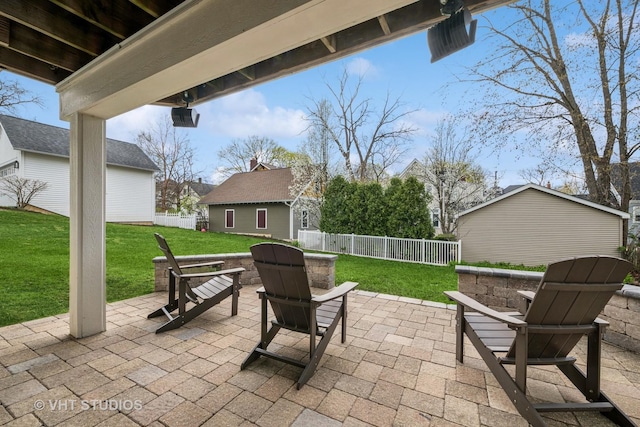 view of patio / terrace with an outdoor structure and a fenced backyard