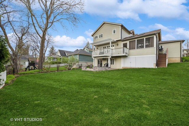 back of property with a sunroom, a fenced backyard, a wooden deck, and a yard