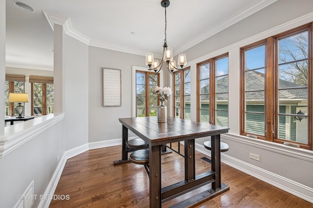 dining space featuring crown molding, visible vents, baseboards, dark wood-style floors, and a notable chandelier