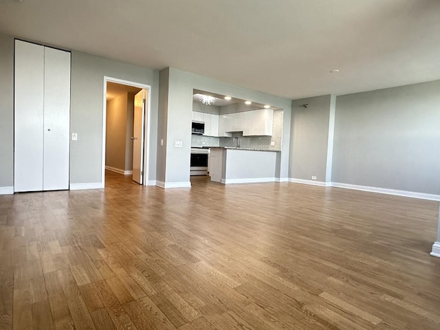 474 N Lake Shore Dr Unit 6102, Chicago, IL 60611 - unfurnished living room featuring baseboards, a sink, and wood finished floors