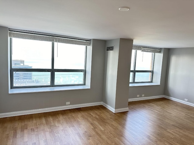 474 N Lake Shore Dr Unit 6102, Chicago, IL 60611 - spare room with wood finished floors, baseboards, and visible vents