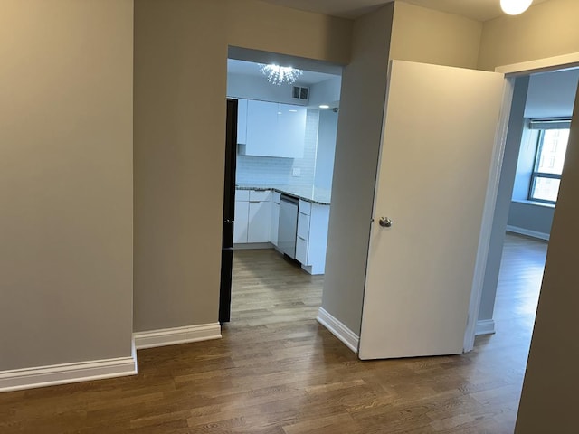 474 N Lake Shore Dr Unit 6102, Chicago, IL 60611 - hall featuring visible vents, baseboards, a chandelier, and wood finished floors