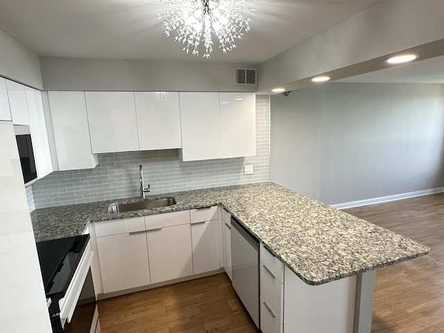 474 N Lake Shore Dr Unit 6102, Chicago, IL 60611 - kitchen featuring a peninsula, white cabinetry, a sink, and wood finished floors