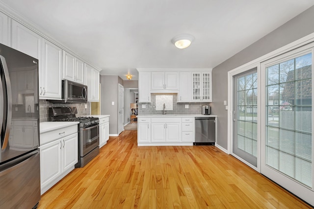 6650 Powell St, Downers Grove, IL 60516 - kitchen featuring tasteful backsplash, light countertops, white cabinets, and stainless steel appliances