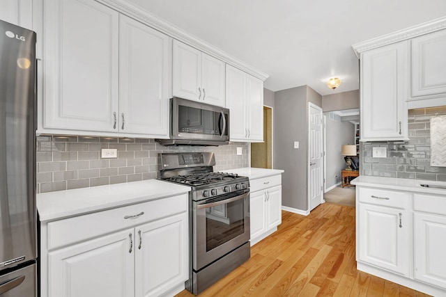 6650 Powell St, Downers Grove, IL 60516 - kitchen featuring stainless steel appliances, baseboards, light countertops, and decorative backsplash