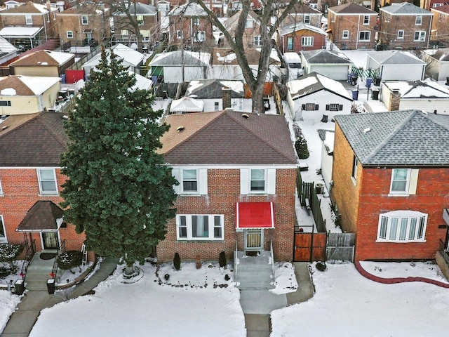 snowy aerial view with a residential view