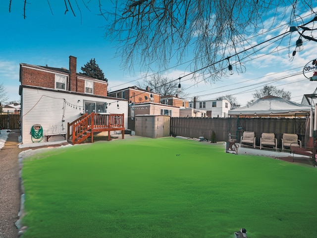 view of yard with a wooden deck and fence