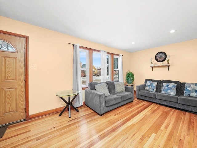 living room featuring recessed lighting, baseboards, and hardwood / wood-style flooring