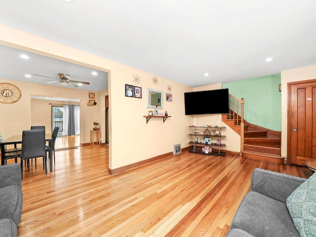 living area featuring wood finished floors, recessed lighting, baseboards, and stairway