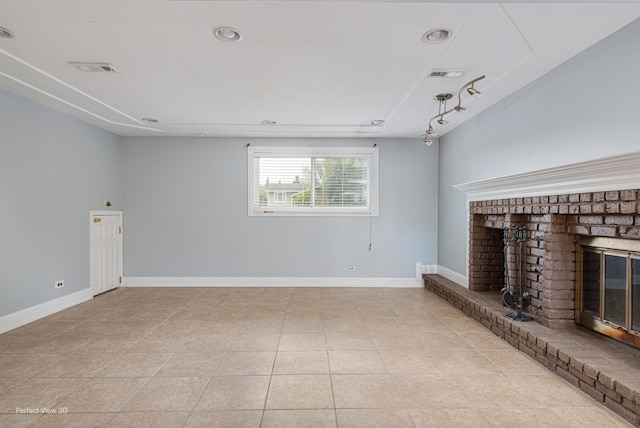 unfurnished living room featuring a brick fireplace, light tile patterned flooring, baseboards, and visible vents