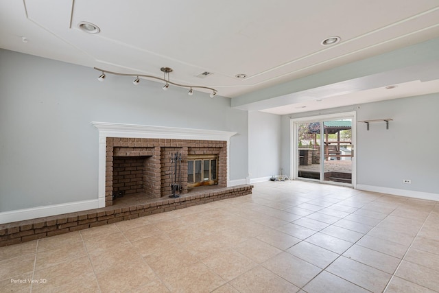 unfurnished living room featuring visible vents, baseboards, a brick fireplace, and tile patterned floors