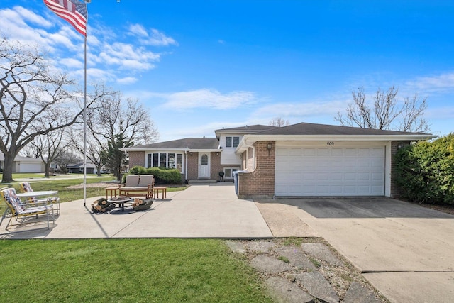 609 Chippewa Ln, Darien, IL 60561 - split level home featuring brick siding, an outdoor fire pit, a front lawn, and concrete driveway