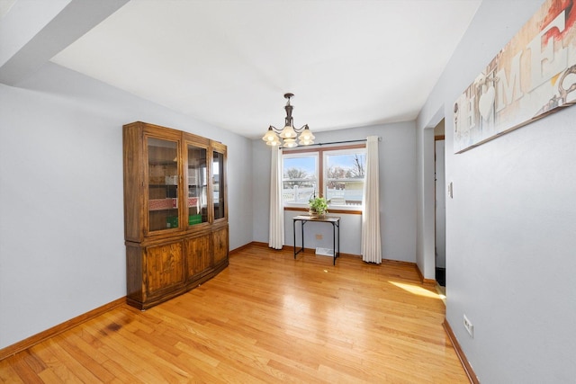 609 Chippewa Ln, Darien, IL 60561 - dining room with a chandelier, light wood finished floors, and baseboards