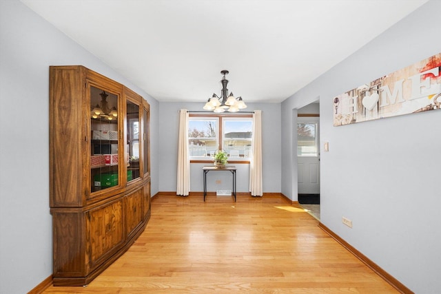 609 Chippewa Ln, Darien, IL 60561 - dining room with light wood-type flooring, an inviting chandelier, and baseboards