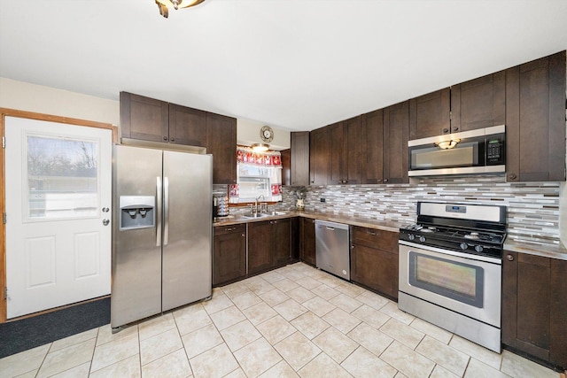 609 Chippewa Ln, Darien, IL 60561 - kitchen with light countertops, appliances with stainless steel finishes, a sink, and dark brown cabinetry