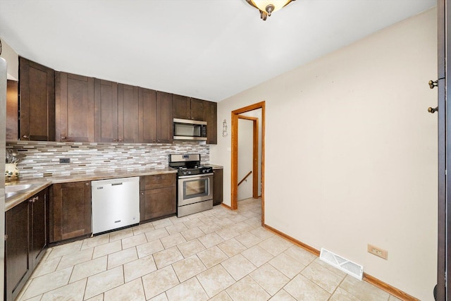 609 Chippewa Ln, Darien, IL 60561 - kitchen featuring tasteful backsplash, visible vents, dark brown cabinets, and appliances with stainless steel finishes