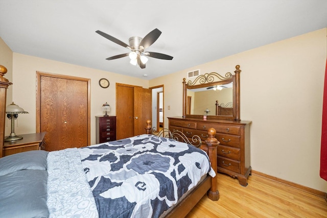 609 Chippewa Ln, Darien, IL 60561 - bedroom with ceiling fan, light wood-type flooring, visible vents, multiple closets, and baseboards