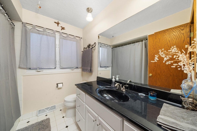609 Chippewa Ln, Darien, IL 60561 - bathroom featuring visible vents, toilet, a textured ceiling, vanity, and tile patterned flooring