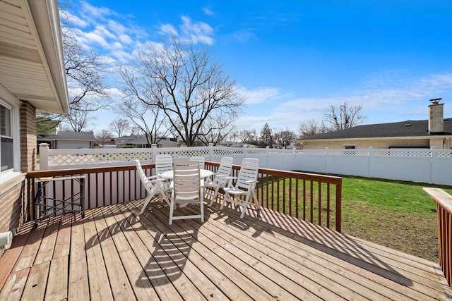 609 Chippewa Ln, Darien, IL 60561 - wooden deck with a fenced backyard, outdoor dining area, and a lawn