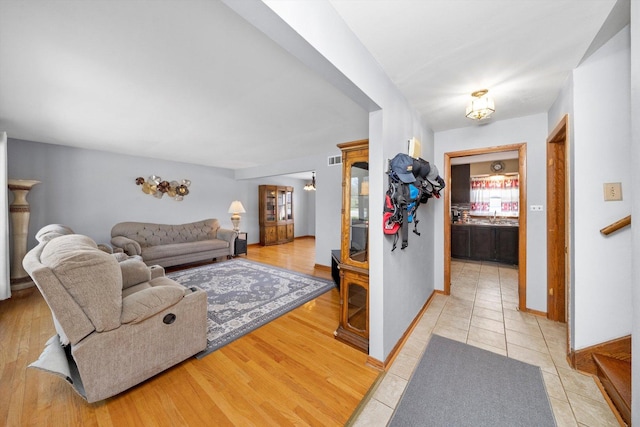 609 Chippewa Ln, Darien, IL 60561 - living area featuring visible vents, baseboards, light wood finished floors, and a wealth of natural light