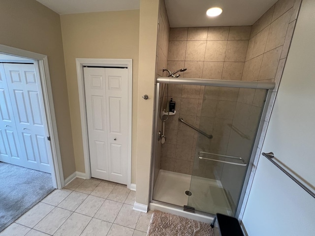 140 S River St Unit 409, Aurora, IL 60506 - bathroom featuring a stall shower, baseboards, and tile patterned flooring