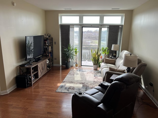 140 S River St Unit 409, Aurora, IL 60506 - living room with visible vents, baseboards, and wood finished floors