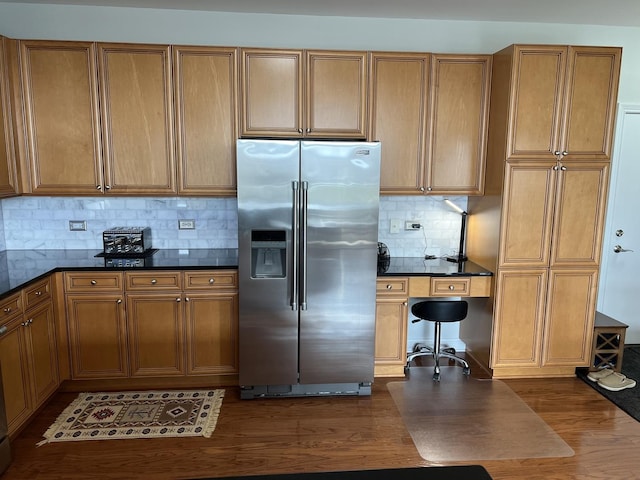 140 S River St Unit 409, Aurora, IL 60506 - kitchen with tasteful backsplash, dark countertops, dark wood-type flooring, brown cabinetry, and high end refrigerator
