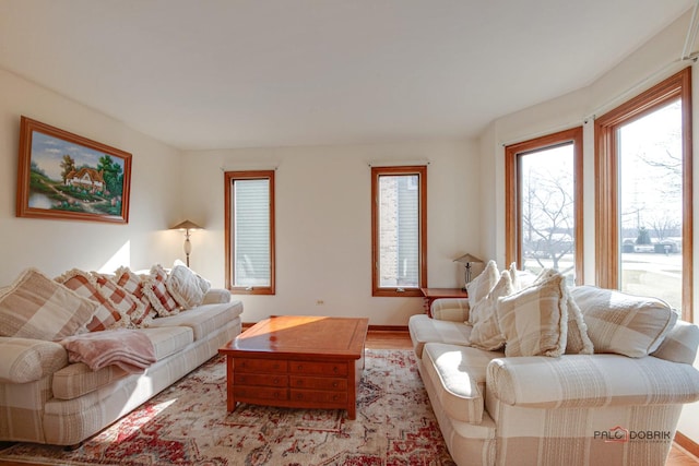 living area with light wood finished floors and baseboards