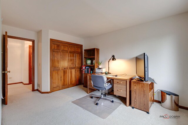 office space with baseboards and light colored carpet