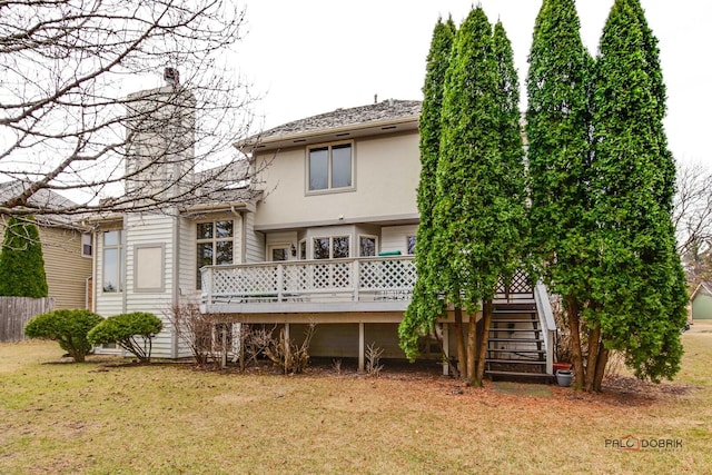 back of house featuring a yard, stairway, stucco siding, and a wooden deck