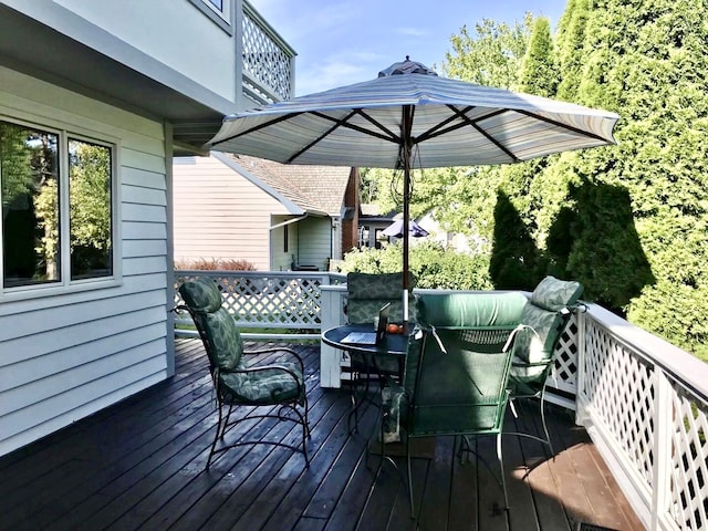 wooden terrace featuring outdoor dining area