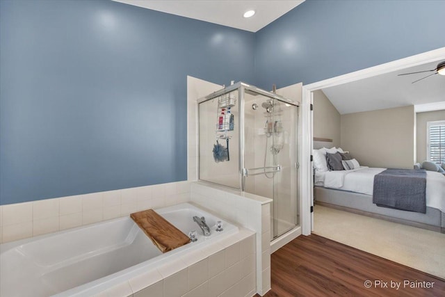 ensuite bathroom with a stall shower, ensuite bath, a bath, ceiling fan, and wood finished floors
