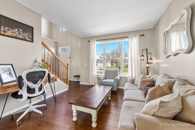 living area with baseboards, stairway, and hardwood / wood-style flooring