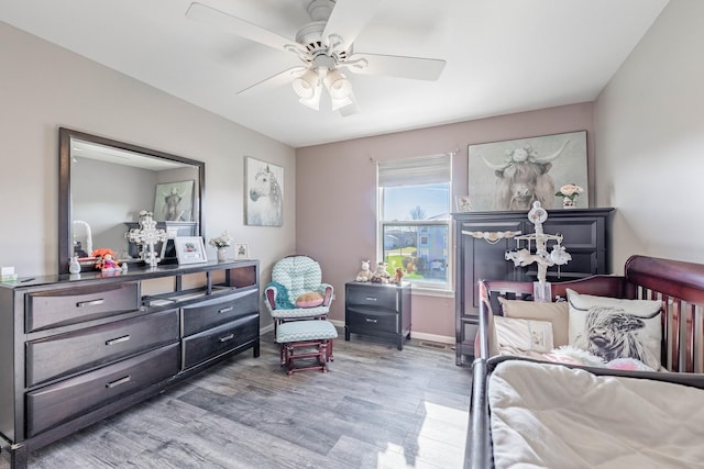 bedroom featuring baseboards, a ceiling fan, and wood finished floors