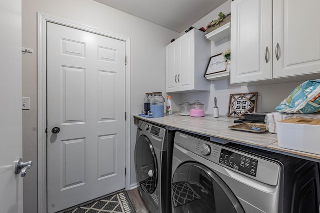 laundry room featuring separate washer and dryer, wood finished floors, and cabinet space