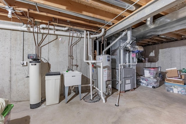 unfinished below grade area with a sink, heating unit, and water heater