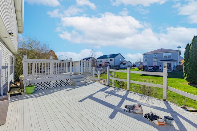 wooden deck with a residential view and a lawn