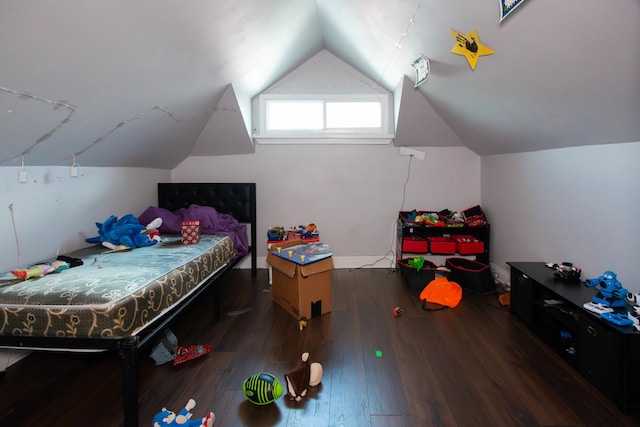 bedroom with wood finished floors and lofted ceiling