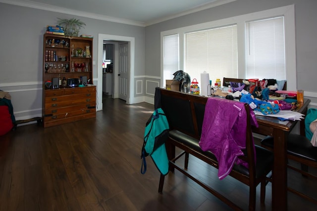home office featuring a decorative wall, ornamental molding, wainscoting, and wood finished floors