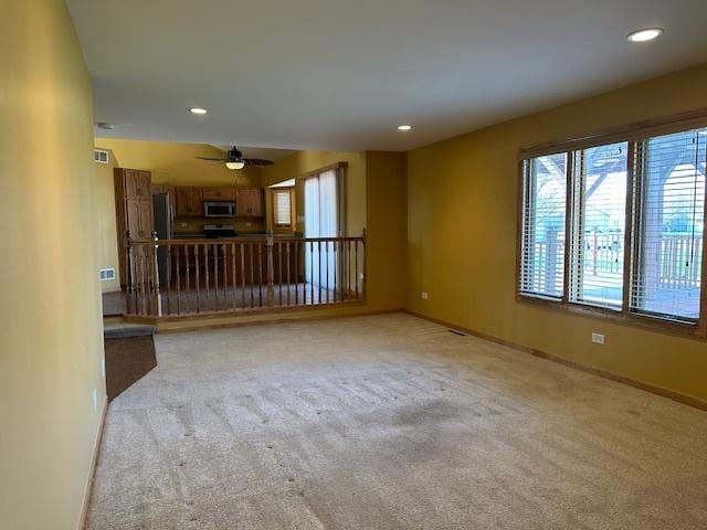 110 E Spring Rd, Coal City, IL 60416 - unfurnished living room featuring a ceiling fan, light colored carpet, and recessed lighting