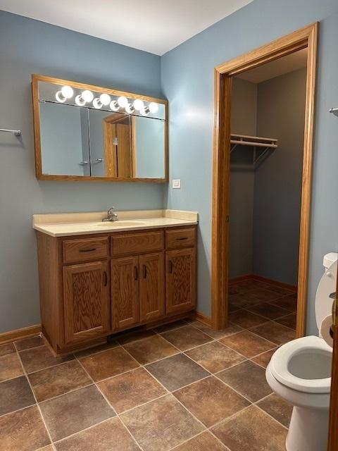 110 E Spring Rd, Coal City, IL 60416 - bathroom with toilet, vanity, and baseboards