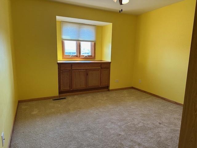 110 E Spring Rd, Coal City, IL 60416 - unfurnished room featuring light colored carpet, baseboards, a ceiling fan, and visible vents