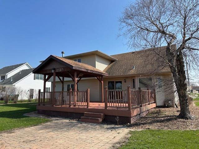 110 E Spring Rd, Coal City, IL 60416 - back of house with roof with shingles, a deck, and a lawn