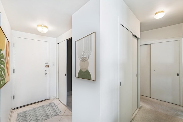 entryway with light tile patterned floors