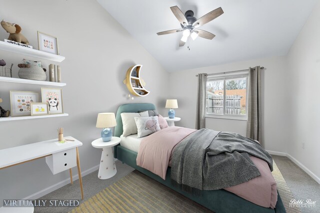 carpeted bedroom with a ceiling fan, baseboards, and lofted ceiling