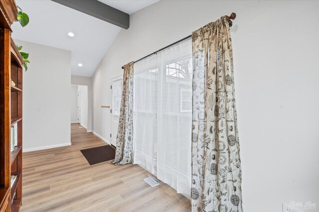 interior space featuring visible vents, wood finished floors, baseboards, lofted ceiling with beams, and recessed lighting