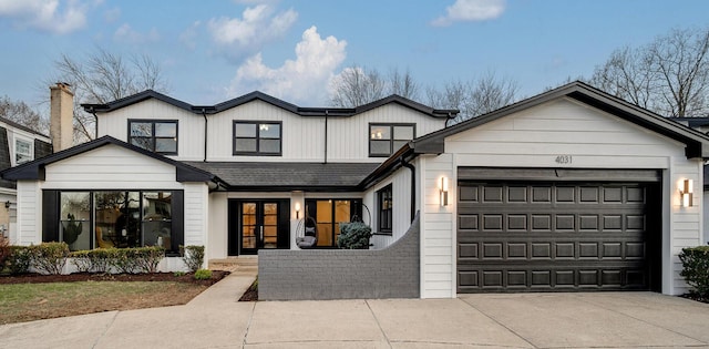 modern inspired farmhouse featuring driveway and a garage