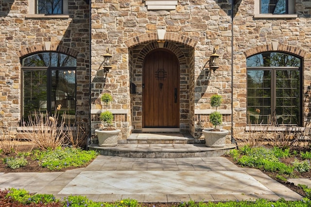 entrance to property featuring stone siding